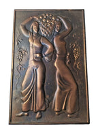 Embossed metal wall art with grapevines and two women figures