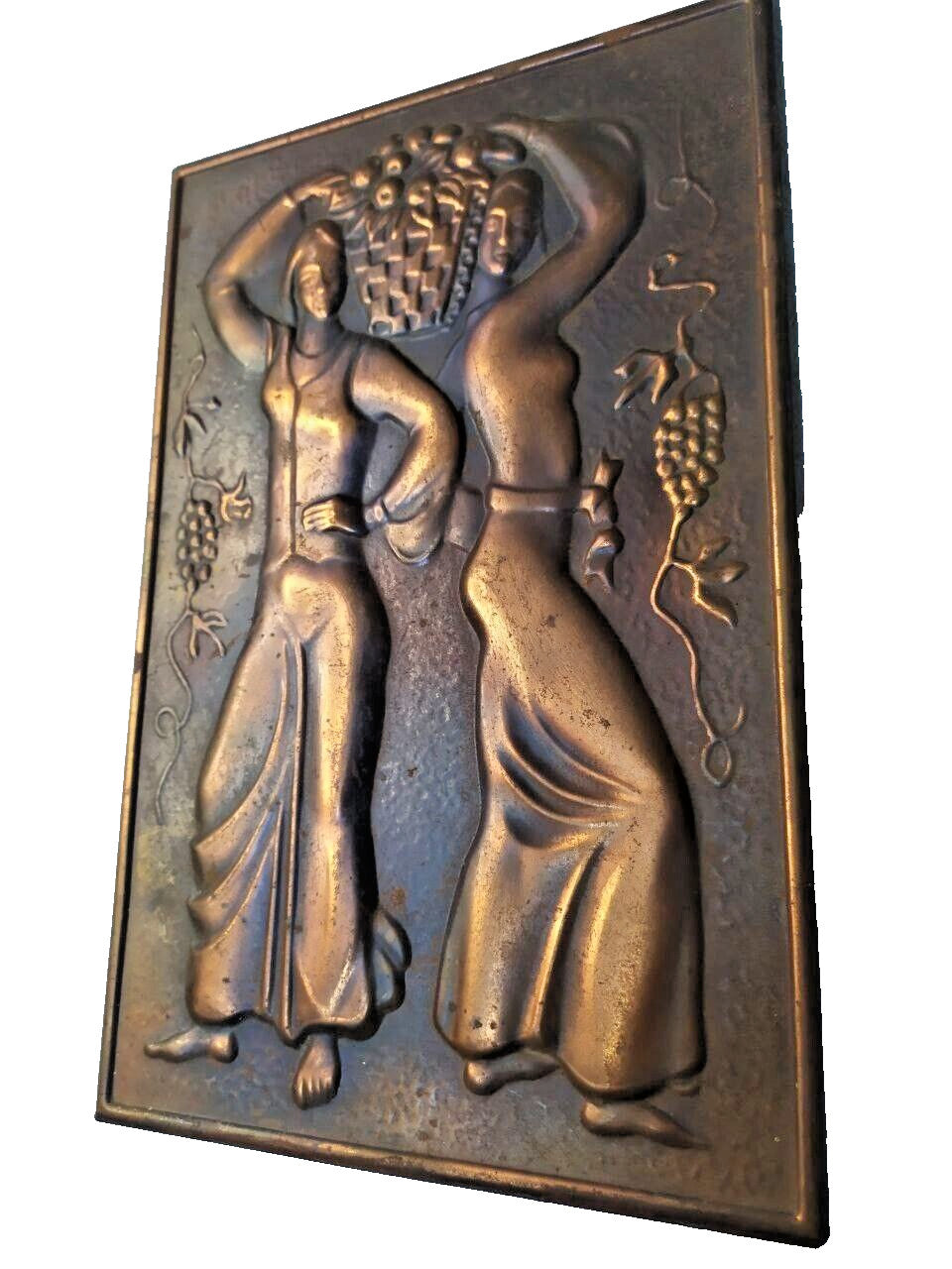 Vintage relief plaque showing natural patina and hammered texture