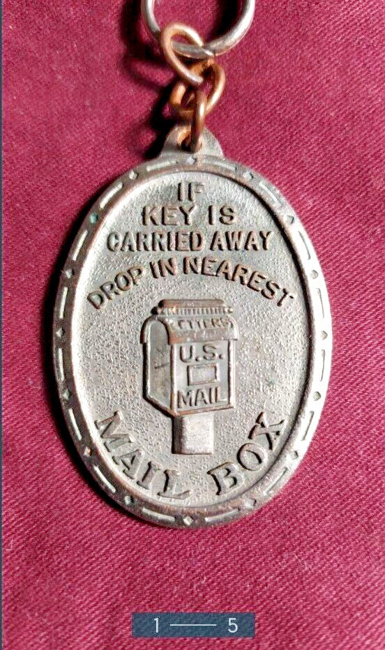 Oval return to owner key tag with decorative border and patina