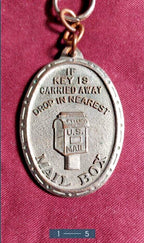Oval return to owner key tag with decorative border and patina