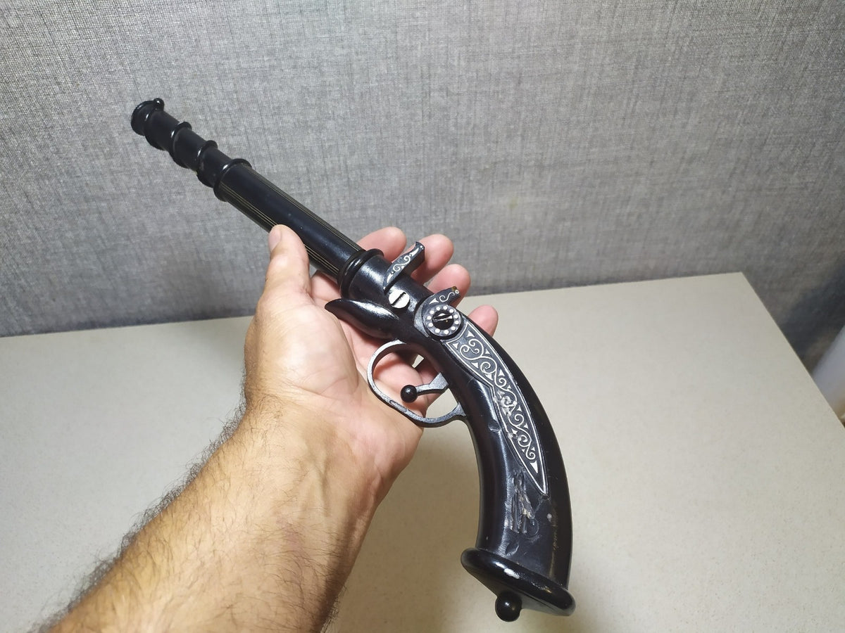 Vintage metal pistol souvenir from the USSR, shown from the side