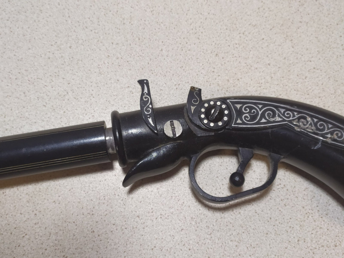 Russian metal pistol souvenir for collectors on display