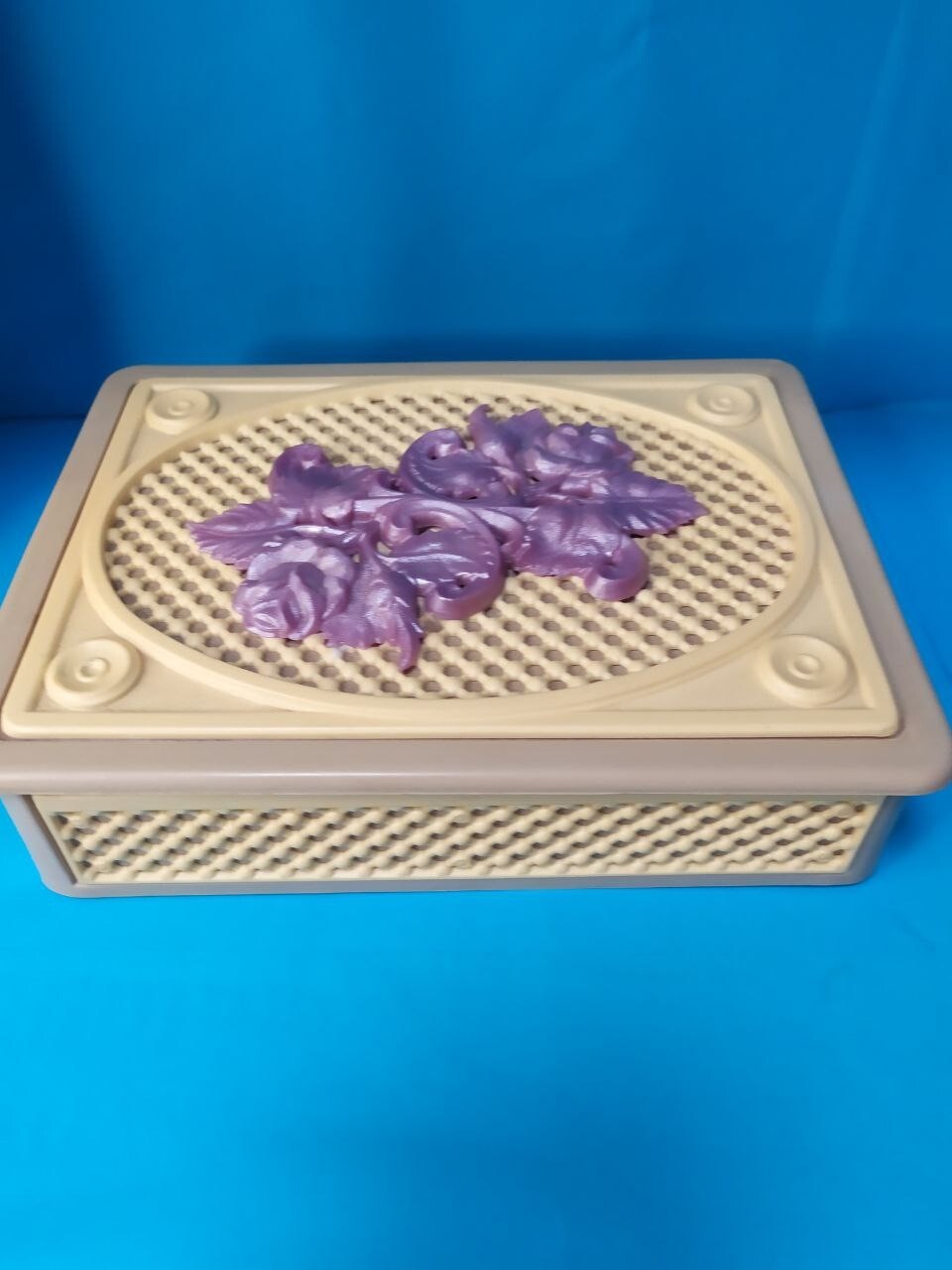 Retro plastic trinket case with raised floral arrangement on the lid