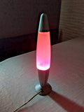 Vintage rocket style lava lamp with silver body and pink purple wax
