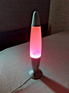 Vintage rocket style lava lamp with silver body and pink purple wax