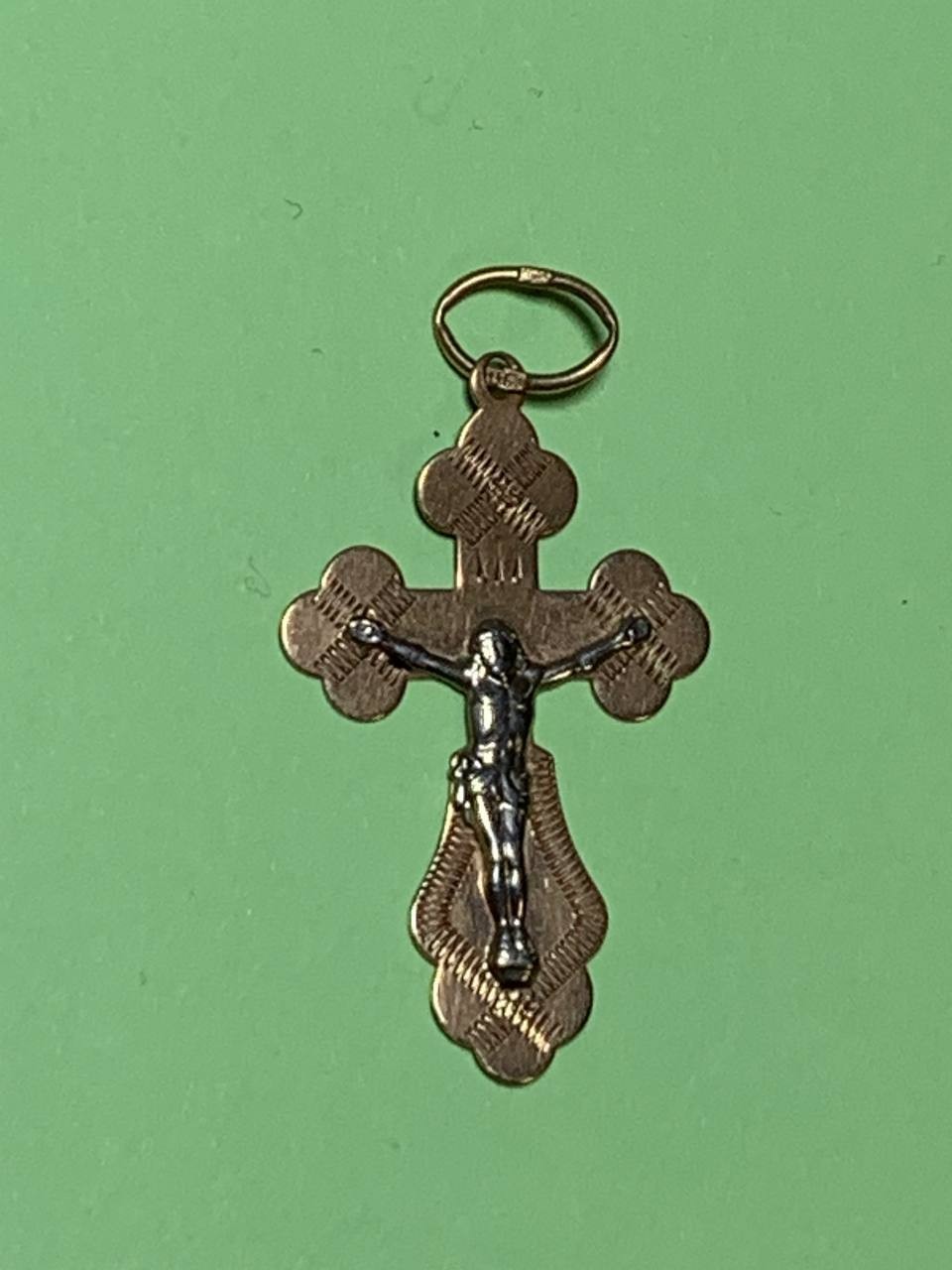 14K gold crucifix pendant with Jesus Christ figure, close-up