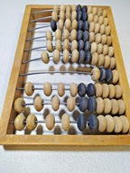 Small Soviet-era abacus next to a tape measure, approx. 30 x 18 cm
