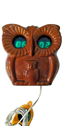 Soviet VFD clock with green glowing digits showing 06:02 in the owl's eyes
