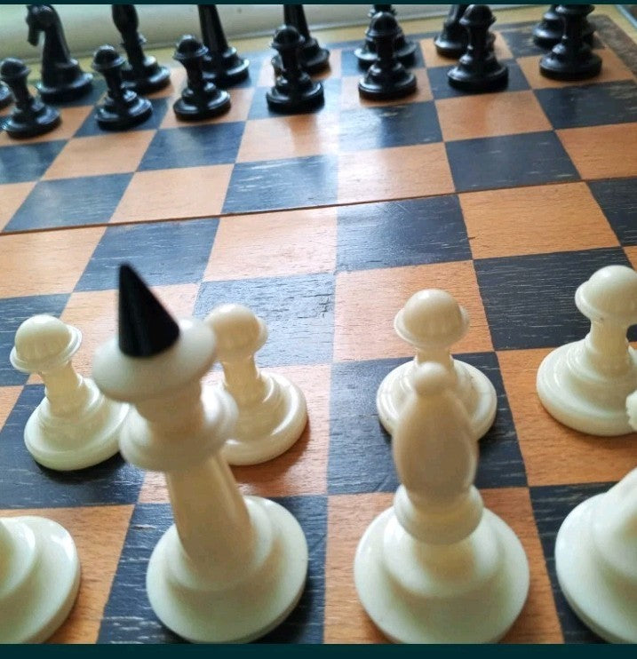 Soviet board game pieces: 16 black and 16 creamy white plastic chessmen