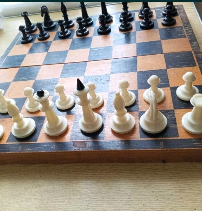 Wear and scratches on the wooden board of a Soviet chess set