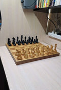 Vintage Soviet chess set with wooden pieces on a folding chessboard