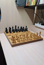 Vintage Soviet chess set with wooden pieces on a folding chessboard