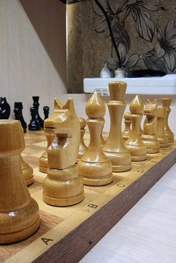 Classic Soviet knight and king chess pieces in light and dark wood