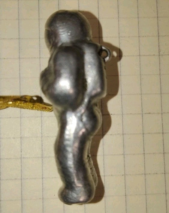 Back of the cosmonaut figurine with hanging loop