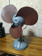 Vintage Soviet desk fan VE-1 from 1972 with brown rubber blades and blue-grey metal body