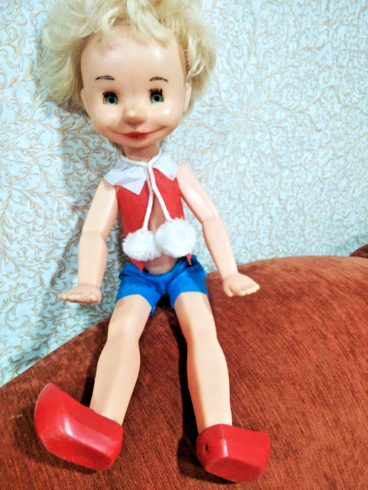 Buratino doll face with green sleep eyes and wide molded smile
