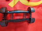 Cast iron hand gripper pair on a scale showing 3.026 kg