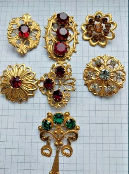 Ruby red faceted crystal brooches in gold-tone settings