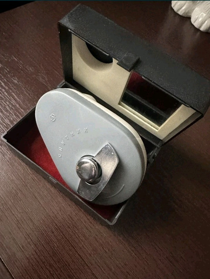 Sputnik-2 wind-up shaver cream and gray body with metal winding key