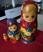 Soviet matryoshka with deep blue apron decorated with red strawberries