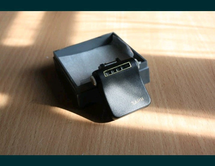 Zarya pedometer with its original gray plastic storage box
