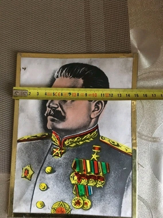 Joseph Stalin portrait with foil-accented uniform and medals, close-up