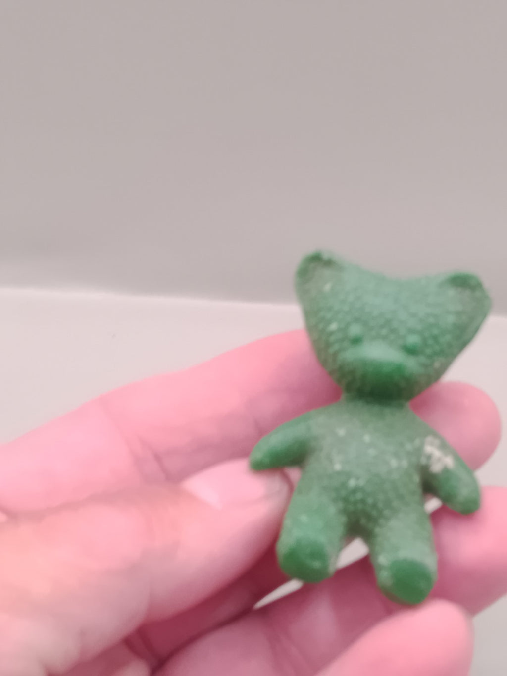 Small green USSR rubber bear figurine, front view