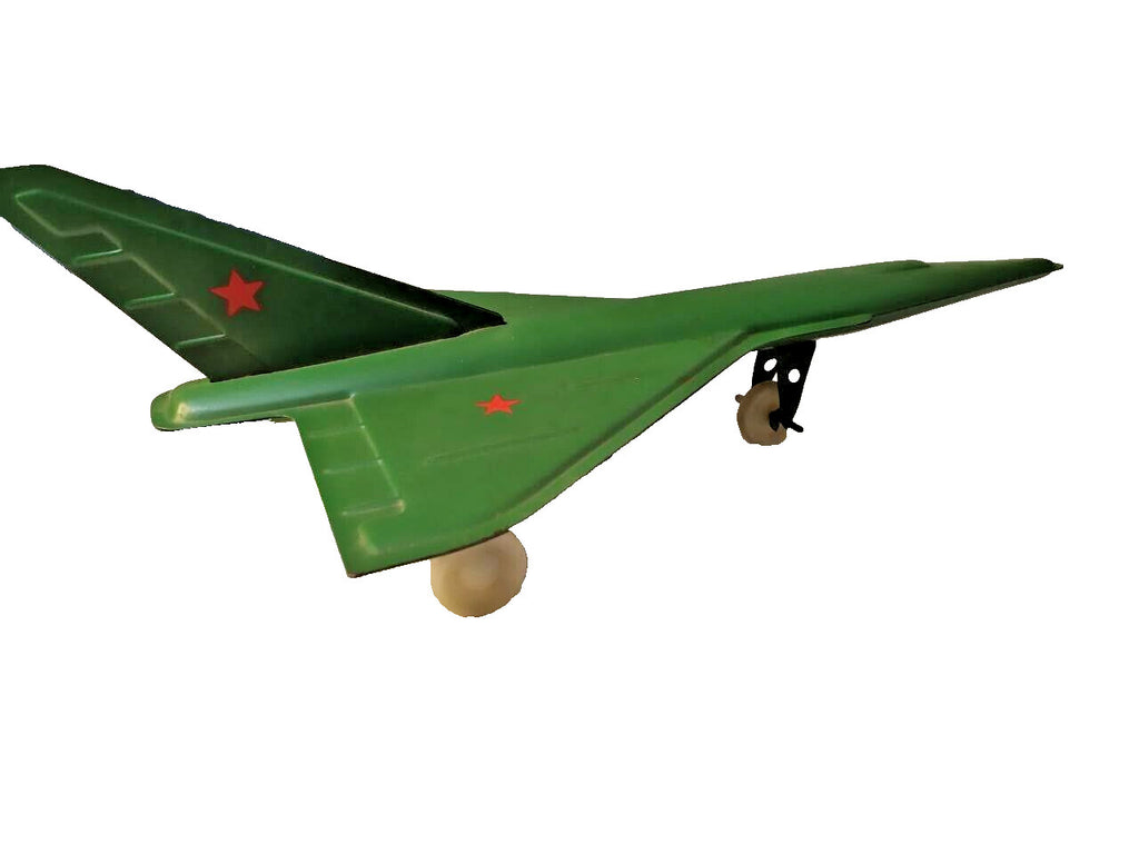 Vintage Soviet toy airplane, green plastic supersonic jet with red stars on wings and tail