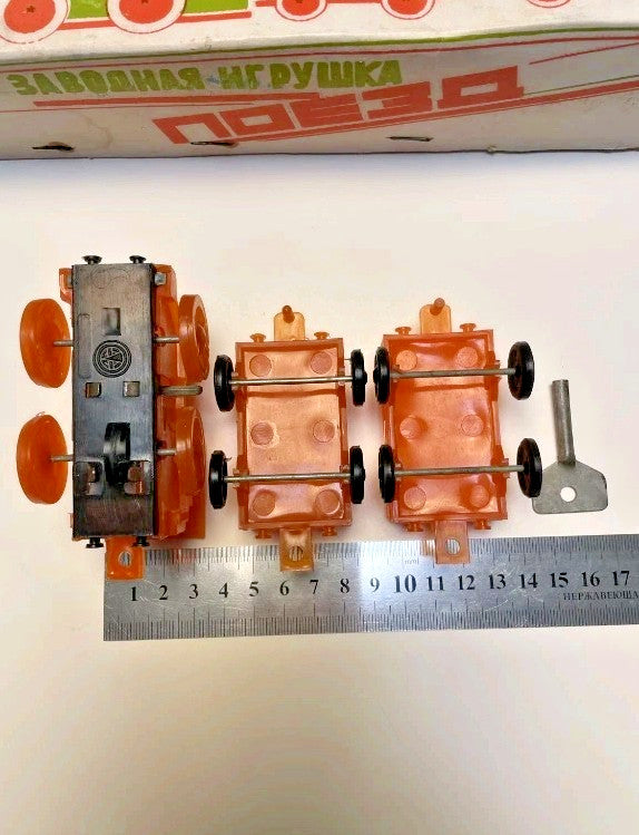 Soviet wind-up toy train locomotive in orange translucent plastic – detail 5