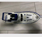 Soviet toy boat with blue decks, railings, radar arch and pilot cabin