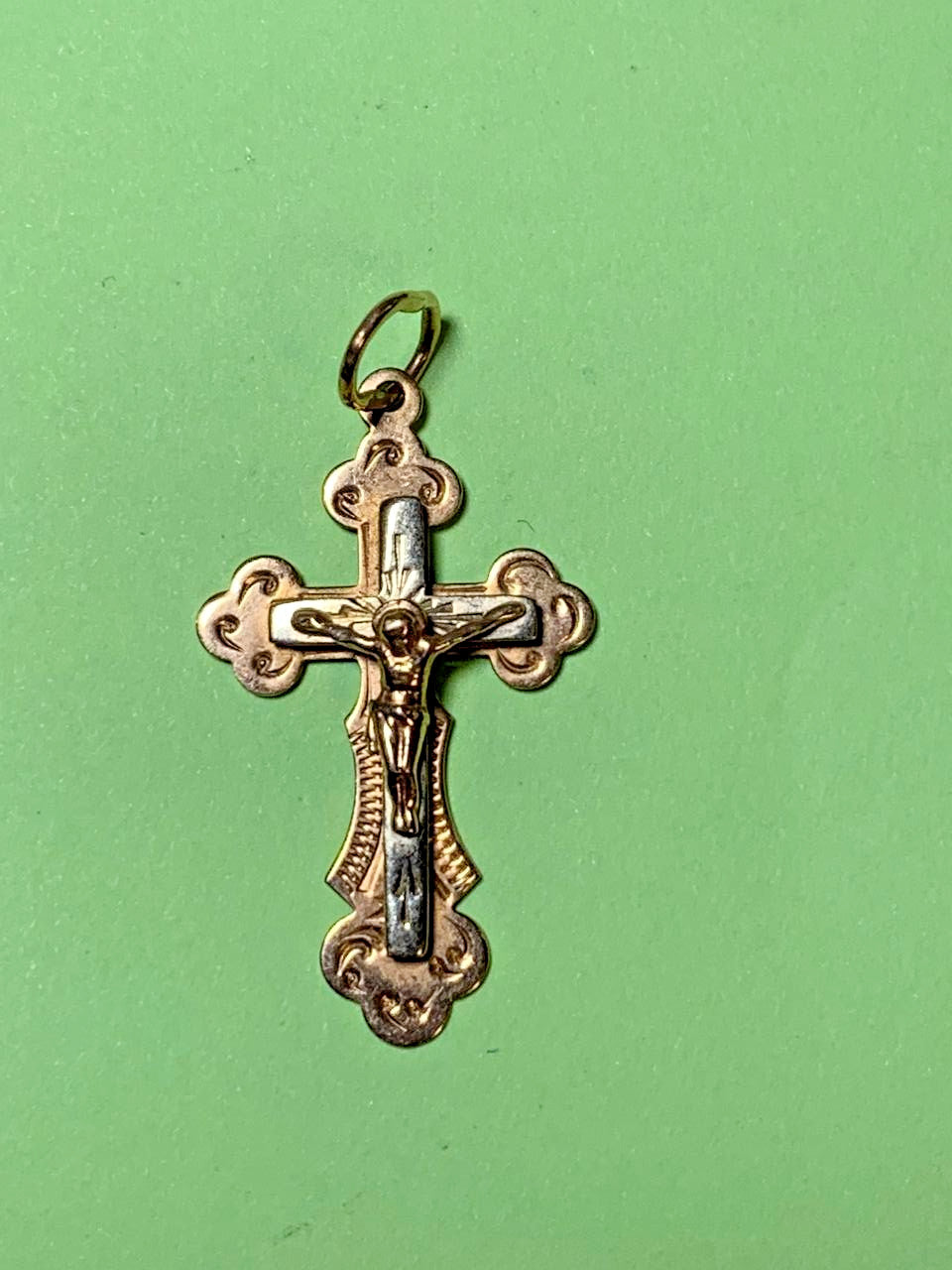 14K gold crucifix pendant with Jesus Christ figure, close-up