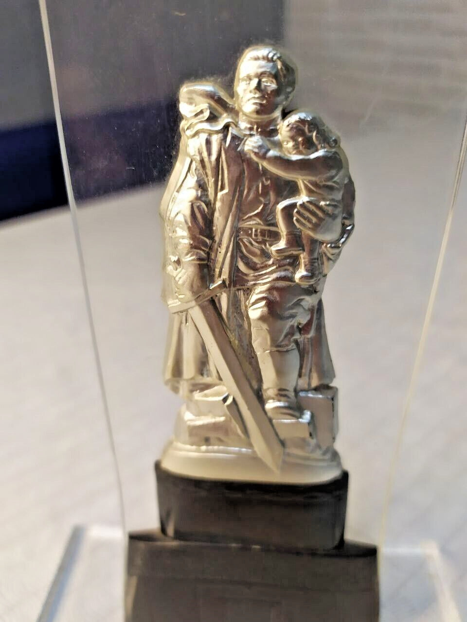 Soviet souvenir statue in transparent plexiglass upright stand on black base