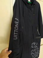 Women's black parka coat with full-length zipper and storm flap