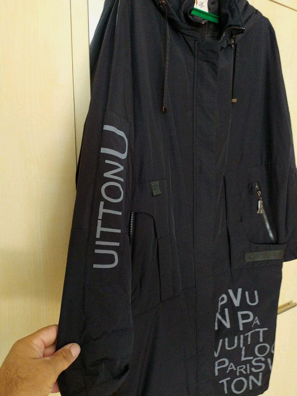 Women's black parka coat with full-length zipper and storm flap