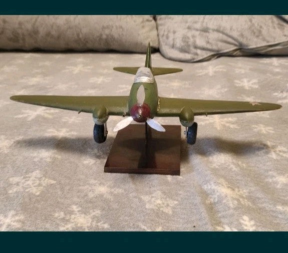 Yak-3 model in green camouflage with red star insignia on wings and tail