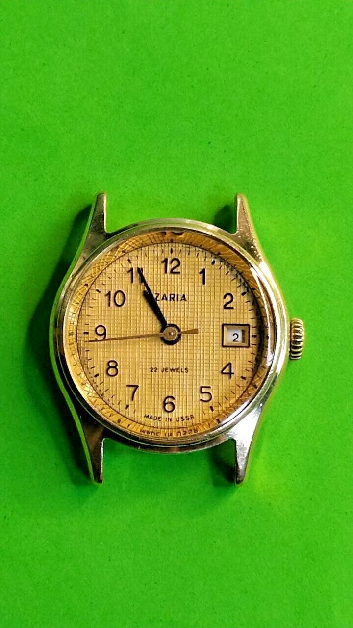 Zaria Soviet mechanical watch with gold-plated case and textured gold-tone dial