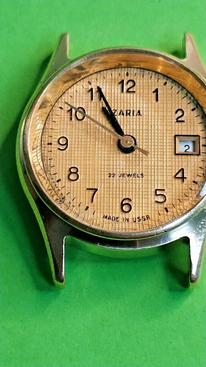 Zaria watch dial with black Arabic numerals and date window at 3 o'clock