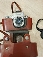 Vintage Zenit-C SLR camera with compact metal body and leatherette