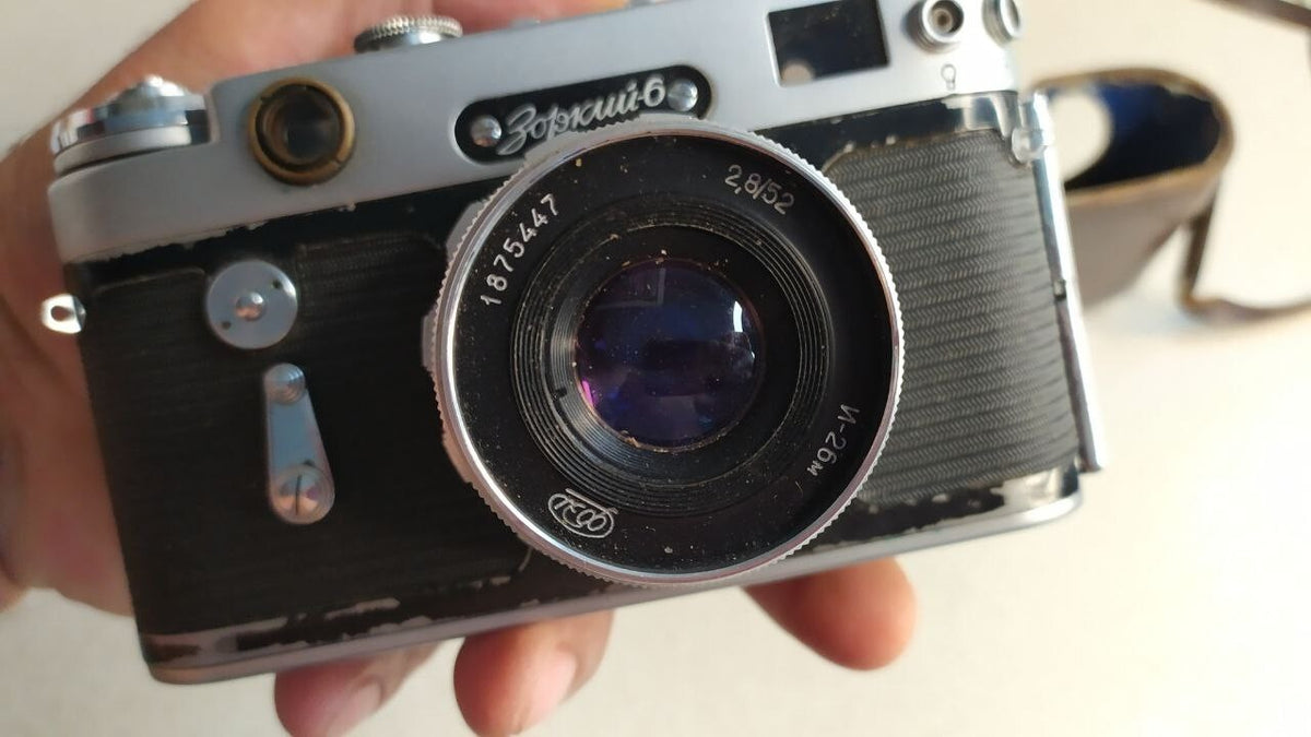 Torn leather ever-ready case that comes with the camera